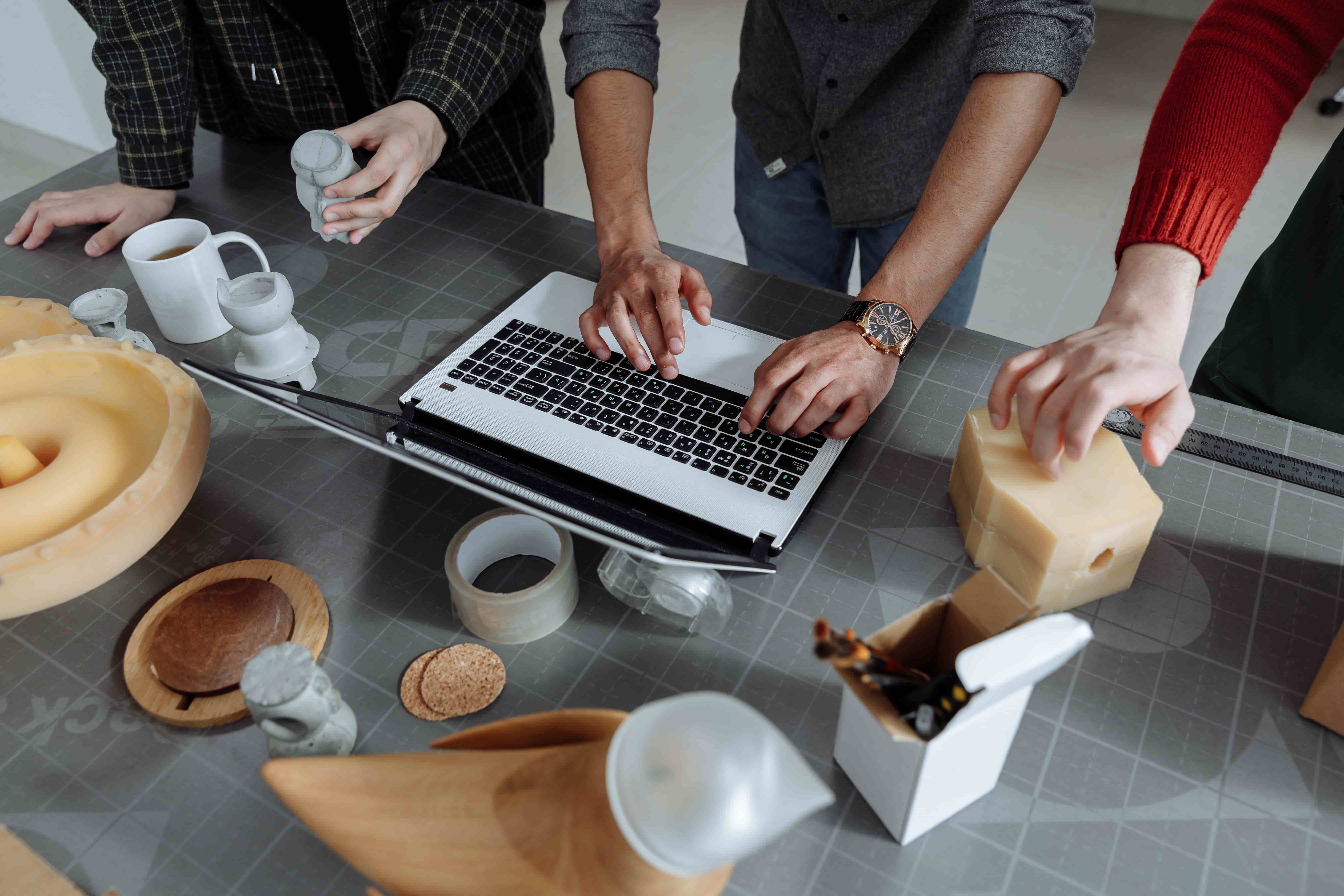 A product team working through implementation details around a laptop